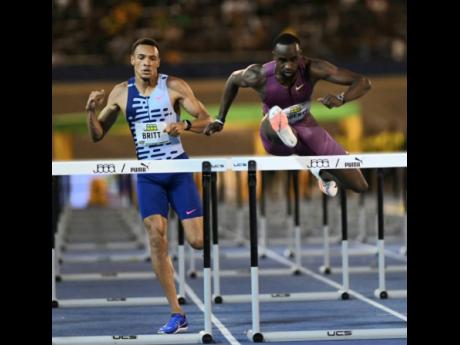 United States of America's Daniel Roberts (right) wins the men's 110m hurdles at the Jamaica Athletics Invitational at the National Stadium tonight.