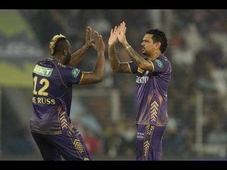 Andre Russell (left) and Sunil Narine of the Kolkata Knight Riders celebrate after the dismissal of Sunrisers Hyderabad batsman Sanvir Singh during yesterday’s Indian Premier League playoff match in Ahmedabad.