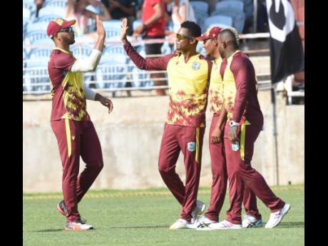From left: West Indies captain Brandon King, Akeal Hosein, Gudakesh Motie, and Fabian Allen celebrate the wicket of South Africa’s Quinton de Kock during the second T20 Interntional between the teams at Sabina Park yesterday.