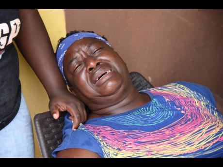 Credit: Ian AllenIan Allen Lucinda Dunkley mourns the death of her son Rafiek Thomas who was shot and killed at his home on Water street, Denham Town, Kingston early Tuesday.
