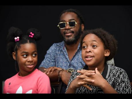 Tafari Wright (right) makes a point while twin sister Ngozi and dad Omaall look on.