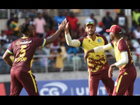 West Indies stand-in captain Brandon King (centre) celebrates the fall of a South African wicket with Matthew Forde (left) and Shamar Joseph during their opening T20 match at Sabina Park on Thursday, May 23. 