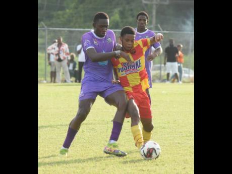 Cornwall College’s Dane Buckley (right) and  Irwin High’s Kenoy Morant  battle for the ball during an ISSA-daCosta Cup match at the Irwin High Sports Complex in St James on October 3, 2023.