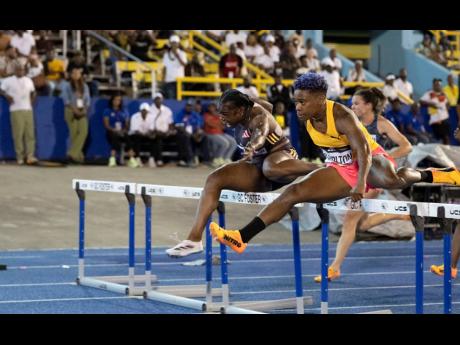 Devynne Charlton (right) of The Bahamas wins the women’s 100m hurdles in 12.64  seconds ahead of Jamaica’s  Yanique Thompson (12.66). 