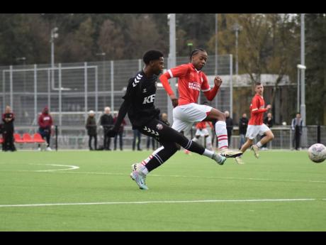 Credit: File Kingston Football Academy under-15 captain Jaeden Morgan (left) strikes the ball ahead of a PSV Eindhoven player during the club’s tour of the Netherlands in April.