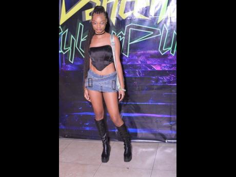 Kerreeme Ballentine rocked a buckled denim skirt with knee-high combat boots.