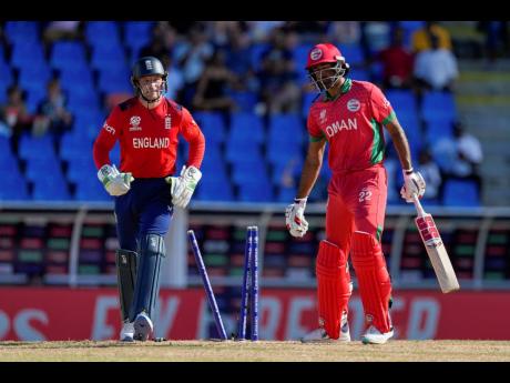 Oman’s Kaleemullah (right) reacts after being bowled by England’s Adil Rashid for five runs during an ICC Men’s T20 World Cup cricket match at Sir Vivian Richards Stadium in North Sound, Antigua and Barbuda, yesterday.