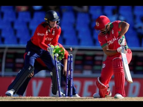 Oman’s Fayyaz Butt is clean bowled by England’s Adil Rashid during an ICC Men’s T20 World Cup cricket match at Sir Vivian Richards Stadium in North Sound, Antigua and Barbuda yesterday.