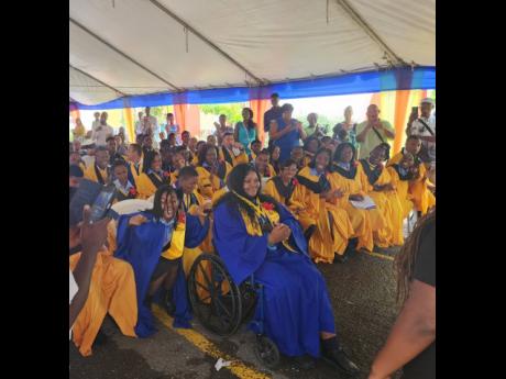 Credit: Tiffany Pryce Valedictorian of the latest graduating batch at the Abilities Foundation Anna-Kay Gibson (foreground) is surrounded by fellow graduates.