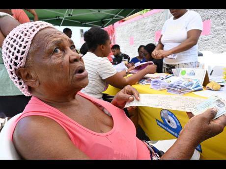 Credit: Rudolph Brown Gloria Adolphus gets ready to replace her old birth certificate.
