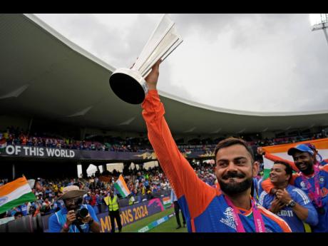 India’s Virat Kohli carries the winners’ trophy as he celebrates after India won the ICC Men’s T20 World Cup final against South Africa at Kensington Oval in Bridgetown, Barbados, on Saturday, June 29. 