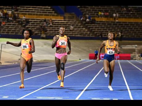 Shericka Jackson (centre)  powering to victory in the women’s 200 metres final in 22.39 seconds at the JAAA/Puma National Junior and Senior Championships yesterday. Lanae-Tava Thomas (left)  placed second in 22.34 and Niesha Burgher (right), third in 22.49.