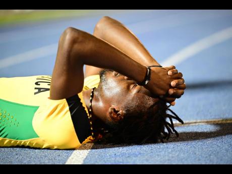 An athlete on the Jamaica Green team that failed to qualify for the men’s 4x400-metre relay at the Paris Olympics lies distraught on the National Stadium track at the JAAA/Puma National Junior and Senior Championships yesterday.
