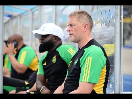 Heimir Hallgrimsson (right) and his assistant Merron Gordon, look on during a Concacaf World Cup qualifier against the Dominican Republic on Thursday, June 6, at the National Stadium.