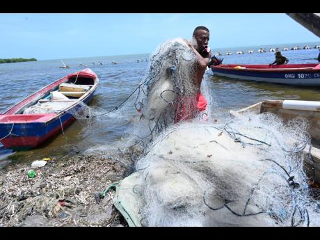 A fisherman secures his nets.