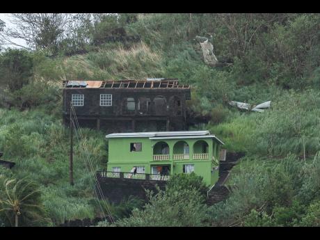 Houses damaged by Hurricane Beryl are spotted in Kingstown, St. Vincent and the Grenadines, on Monday. 