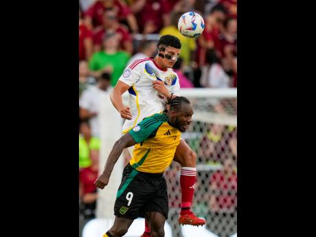 Venezuela’s Yordan Osorio (top) and Jamaica’s Michail Antonio compete for the ball during a Copa America match Sunday, June 30, 2024, in Austin, Texas. Venezuela won 3-0.