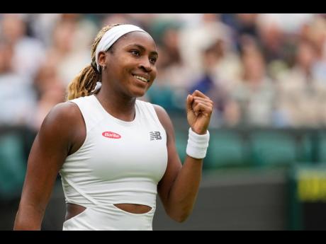 Coco Gauff of the United States reacts after defeating Anca Todoni of Romania in their match on day three at the Wimbledon tennis championships in London yesterday.