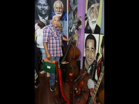 King Jammy stands next to his mural in the Hall of Fame.