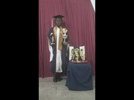 Credit: Contributed Shanessa Williams poses with the many trophies she was awarded at her graduation from Cedar Grove Academy in Portmore, St Catherine, on Sunday.