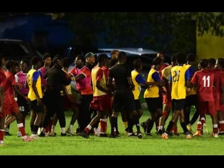 Credit: Antoine Lodge Players and spectators on the field after a brawl broke out during the KSAFA Under-17 final between Liguanea Unted and Boys’ Town FC at the Constant Spring Football Field last night.