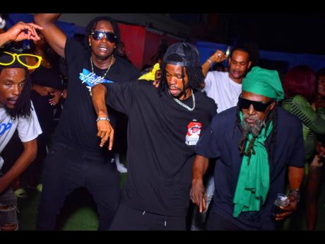 Reggae legend Junior Reid (right) shows he still has the energy as he and several dancers enjoy the music at Leggo Di Streets.