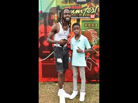 Dancehall artiste Laa Lee (left) poses with 12-year-old Dwight ‘DJ Brainz’ Francis.