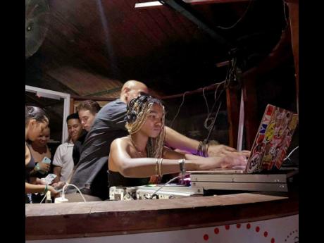 DJ Ziza performing at an event at her school in the US.