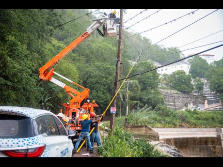 A Jamaica Public Service crew performs restoration work following the passage of Hurricane Beryl.  