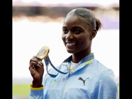 Credit: Gladstone Taylor Olympic champion Julien Alfred of St Lucia displays her gold medal during the Medal Ceremony for the women’s 100m at the Stade de France in Paris, France, yesterday.