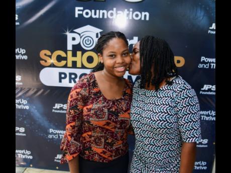 Credit: Antoine Lodge Shadelle Brown gets a kiss from her mother, Jevan Clarke Brown, at the JPS Foundation’s Power Up Scholarship Awards Ceremony, held at Terra Nova All-Suite Hotel in St Andrew last weekend.