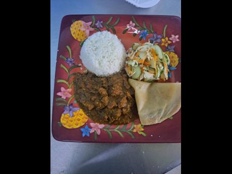 Curried goat with roti and vegetables at the festival.
