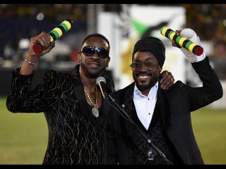 Dancehall legends Bounty Killer (left) and Beenie Man celebrate their award Reggae Icon Awards at the Grand Gala at the National Stadium on Tuesday.