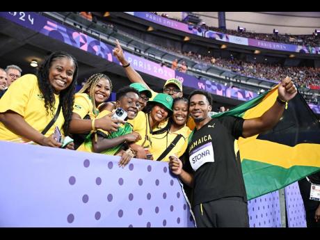 Credit: Gladstone Taylor Roje Stona (right) of Jamaica celebrates his history-making gold in the men’s discus final with family and Jamiacan supporters at the Stade de France in Paris, France.