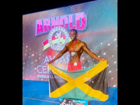 Daniel Haughton displaying the Jamaica flag at a previous edition of the Arnold Classic Europe IFBB Elite Pro World Championships awards ceremony. 