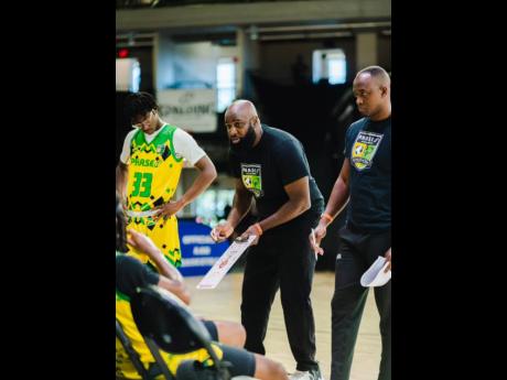 Wayne Dawkins (centre), CEO of P.H.A.S.E. 1 Academy, speaking to his players at the Orlando AAU Nationals in Orlando, Florida, from July 3- 5. Looking on at right is  assistant coach Dave Black.