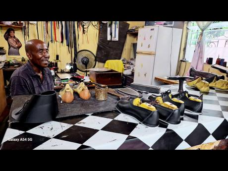 Credit: Almando Smith Shoemaker Archibald ‘Pinky’ Davis shows off some of his creations.