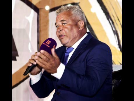 Credit: Antoine Lodge Photos Craig Butler, head coach of Mona High, speaking at the launch of the ISSA schoolboy football season at Stadium East on Wednesday evening.