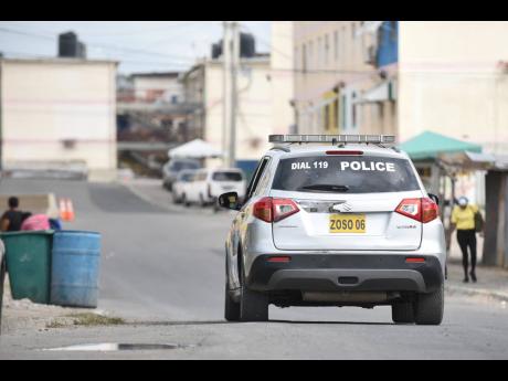 Credit: FILE Photos A police service vehicle patrols the west Kingston community of Denham Town.