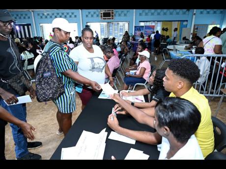 Credit: Rudolph Brown Beneficiaries receive their Hurricane Beryl relief cheques at the handover in Portmore, St Catherine.