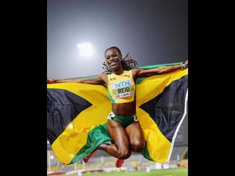 Alana Reid celebrates her 100-metre victory at the World Under-20 Championships inside the Estadio Atletico de la Videna in Lima, Peru, yesterday.