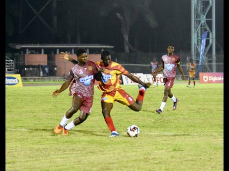 Herbert Morrison Technical High School’s Dantay Morle (left) and Cornwall College’s Carlondo Morris battle for the ball during their opening match of the ISSA/WATA daCosta Cup football competition at the Montego Bay Sports Complex on Saturday, September 7. Cornwall won 4-1.