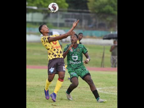 Christopher Hylton (left) of Haile Selassie High School and Jaheim Rankine of Calabar High compete for the ball during their ISSA/WATA Manning Cup football match at Calabar High School on Wednesday. Calabar won 3-0.