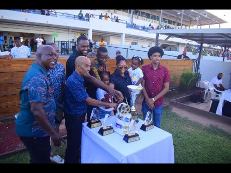 Connections of COMEHOMETOME, ridden by Tevin Foster, celebrate its victory in the ninth race, The Winston “Fanna” Griffiths OD Classic over 9 1/2 furlongs at Caymanas Park on Sunday. The event was a three-year-old and upwards Graded Stakes.