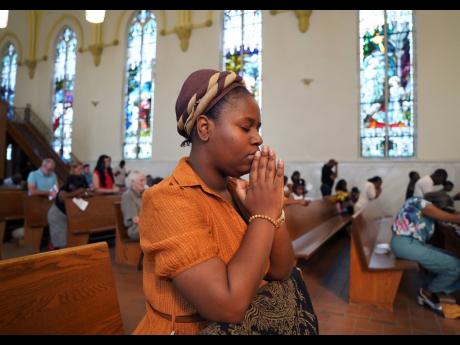 Marie Morette, a congregant of St Raphael Catholic Church, prays during Mass in Springfield, Ohio, on Sunday.