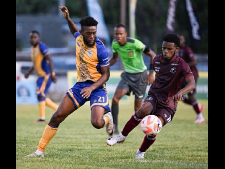 Harbour View’s Odorland Harding pressures Chapelton Maroons’ Malike Stephens during the Jamaica Premier League football match at the Anthony Spaulding Sports Complex on Monday. Chapelton Maroons won 2-1.