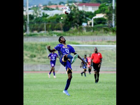 Rashard Farrington of Cumberland High School prepares to control the ball during the ISSA/WATA football match against Kingston College at Stadium East. KC won 18-0.