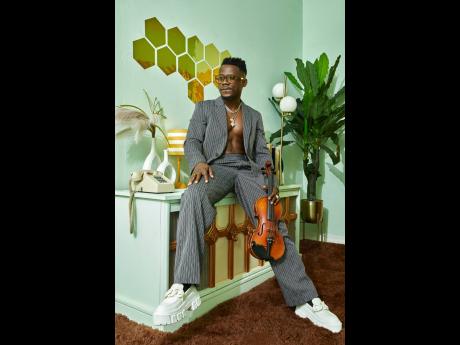 ‘Demola the violinist’ poses with his ‘magical instrument’ during one of his photo shoots.