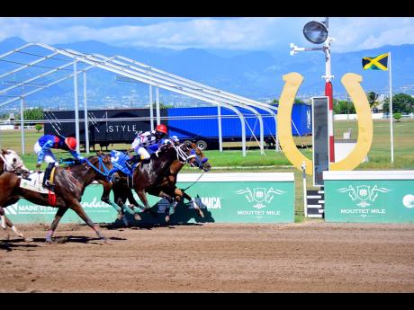 PRINCESS IFIYAH (No.3), ridden by Paul Francis, battles to the wire with MISS LINTON (partly hidden, against the rails) in the fifth race over 5 1/2 furlongs at Caymanas Park on Sunday. MISS LINTON, first past the post, was disqualified for causing interference. The race was awarded to PRINCESS IFIYAH.