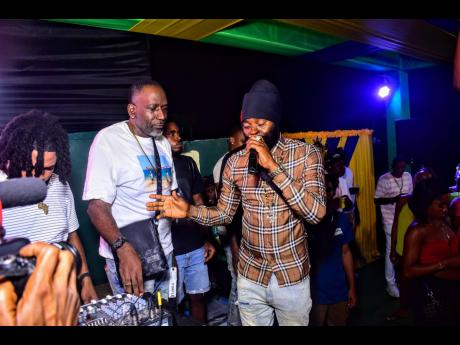 Recording artist Bugle (right) was present to ‘big up’ Tall Boss on his celebration.
